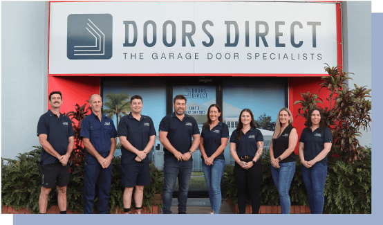 Group photo of the Doors Direct team standing outside in front of their company signage.